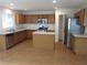 Spacious kitchen features wood cabinets, stainless steel appliances, and a center island for ample prep space at 215 Silver Spring St, Dallas, GA 30157
