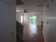 Shows an open-concept living room with light walls, wood flooring, and natural light from sliding glass doors at 215 Silver Spring St, Dallas, GA 30157