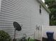 Features the side of a house with light blue siding, an electrical box, and a satellite dish at 215 Silver Spring St, Dallas, GA 30157