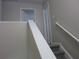Carpeted staircase with white railing leading to the second floor of the home at 215 Silver Spring St, Dallas, GA 30157