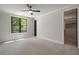 Sunlit bedroom with neutral carpet, window view and walk-in closet at 4091 Oak Forest Drive Ne, Brookhaven, GA 30319
