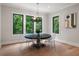 Bright dining area with a round table, transparent chairs, and serene views of the lush outdoors at 4091 Oak Forest Drive Ne, Brookhaven, GA 30319