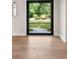 Foyer featuring a black-framed glass door, hardwood floors, and views of the front yard at 4091 Oak Forest Drive Ne, Brookhaven, GA 30319