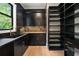 Modern kitchen features black cabinetry, stone countertops, and a large pantry at 4091 Oak Forest Drive Ne, Brookhaven, GA 30319