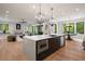 Open concept kitchen with an island, modern appliances, and seamless connection to the living and dining areas at 4091 Oak Forest Drive Ne, Brookhaven, GA 30319