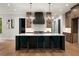 Modern kitchen island features pendant lighting and seating, complementing the sleek cabinets and countertops at 4091 Oak Forest Drive Ne, Brookhaven, GA 30319