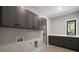 Well-equipped laundry room with stylish cabinetry, counter space, and window at 4091 Oak Forest Drive Ne, Brookhaven, GA 30319