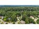 A beautiful home nestled in a lush, green, wooded neighborhood is seen from an aerial view at 4995 Aviary Nw Dr, Acworth, GA 30101