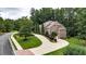 Aerial shot showcasing a well-landscaped yard, mature trees, and a long, paved driveway at 4995 Aviary Nw Dr, Acworth, GA 30101