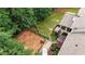 Aerial view of fenced yard, patio, deck, hot tub, landscaping, and mature trees at 4995 Aviary Nw Dr, Acworth, GA 30101