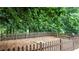 Fenced backyard with mulch, offering a safe area surrounded by lush, mature trees at 4995 Aviary Nw Dr, Acworth, GA 30101