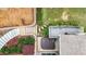 Backyard featuring a patio with a hot tub, lush landscaping, and stone paver steps at 4995 Aviary Nw Dr, Acworth, GA 30101