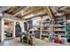 Unfinished basement featuring exposed ceiling, storage, and work area with shelving and work table at 4995 Aviary Nw Dr, Acworth, GA 30101