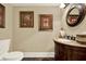 Bathroom with granite vanity, oval mirror, framed paintings and tile floor at 4995 Aviary Nw Dr, Acworth, GA 30101