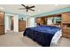 Spacious bedroom with large bed, ceiling fan, and natural light, exuding comfort and relaxation at 4995 Aviary Nw Dr, Acworth, GA 30101