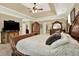 Spacious bedroom featuring decorative furniture, tray ceilings and tan walls at 4995 Aviary Nw Dr, Acworth, GA 30101