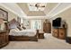 Large bedroom featuring a tray ceiling, neutral carpeting, and decorative furniture at 4995 Aviary Nw Dr, Acworth, GA 30101