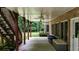 Brick-column-supported patio with ceiling fans, wooden steps, and access to yard and storage at 4995 Aviary Nw Dr, Acworth, GA 30101