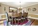 Formal dining room featuring an ornate mirror, chandelier, and seating for eight at 4995 Aviary Nw Dr, Acworth, GA 30101