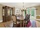Dining room boasting hardwood flooring, chandelier, display cabinet, and large windows at 4995 Aviary Nw Dr, Acworth, GA 30101