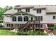 Rear exterior with a deck, stairs to the yard, and a hot tub on the patio at 4995 Aviary Nw Dr, Acworth, GA 30101