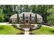 Beautifully landscaped home featuring a lush green lawn, mature trees, and manicured shrubs at 4995 Aviary Nw Dr, Acworth, GA 30101