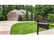 Inviting home exterior with manicured lawn, mature trees, and a decorative mailbox at 4995 Aviary Nw Dr, Acworth, GA 30101