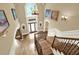 Grand foyer featuring hardwood floors, a high ceiling, chandelier, and staircase with decorative iron railings at 4995 Aviary Nw Dr, Acworth, GA 30101