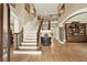 A grand foyer showcases an elegant staircase, hardwood floors, and custom built-in shelving at 4995 Aviary Nw Dr, Acworth, GA 30101