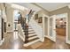 Foyer features an elegant staircase and chandelier, showcasing the entrance of the home at 4995 Aviary Nw Dr, Acworth, GA 30101