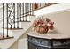 Close-up view of the staircase, decorative table, and wrought iron railing at 4995 Aviary Nw Dr, Acworth, GA 30101