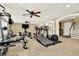 Large gym area with treadmill, weight machines, mounted TV and ceiling fan at 4995 Aviary Nw Dr, Acworth, GA 30101