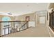 Upstairs hallway with carpet floors, crown molding, and railings overlooking the foyer at 4995 Aviary Nw Dr, Acworth, GA 30101