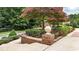 Well-maintained landscaping with brick retaining wall, flowers, and lush greenery at 4995 Aviary Nw Dr, Acworth, GA 30101
