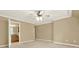 Spacious main bedroom with neutral walls, plush carpet, and a doorway to the ensuite bathroom at 4995 Aviary Nw Dr, Acworth, GA 30101