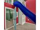 Play area with a blue slide, ladder to the red playhouse, and built-in shelves at 4995 Aviary Nw Dr, Acworth, GA 30101