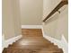 Hardwood steps with painted risers and a wooden handrail leading to the next level at 4995 Aviary Nw Dr, Acworth, GA 30101