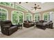 Bright sunroom features multiple seating areas and large windows providing serene views at 4995 Aviary Nw Dr, Acworth, GA 30101