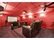 Home theater with leather recliners, projector, screen, and red walls at 4995 Aviary Nw Dr, Acworth, GA 30101