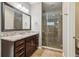 Bathroom features a glass shower, granite countertop, ceramic tile, and wood cabinets at 5365 Vendelay Ln, Cumming, GA 30040
