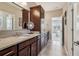 Bathroom vanity boasts granite counters, wood cabinetry and decor leading to the bedroom at 5365 Vendelay Ln, Cumming, GA 30040