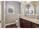 Bathroom with granite countertops, dark wood cabinets, and chrome fixtures at 5365 Vendelay Ln, Cumming, GA 30040