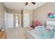 Cozy bedroom with neutral walls, ceiling fan and ample space for play or relaxation at 5365 Vendelay Ln, Cumming, GA 30040