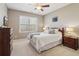 Comfortable bedroom features a full-sized bed, neutral color scheme, and large windows at 5365 Vendelay Ln, Cumming, GA 30040