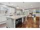 Bright and airy kitchen with granite countertops, a center island, white cabinetry, and hardwood floors at 5365 Vendelay Ln, Cumming, GA 30040