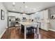 Kitchen featuring white cabinets, granite countertops, a large island with seating, and stainless appliances at 5365 Vendelay Ln, Cumming, GA 30040