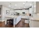 Well-lit kitchen boasts white cabinetry, stainless steel appliances, and a spacious granite island at 5365 Vendelay Ln, Cumming, GA 30040