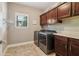 Laundry room with front-load washer/dryer, storage cabinets, and a folding counter at 5365 Vendelay Ln, Cumming, GA 30040