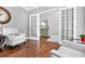 Elegant living room showcasing hardwood floors, French doors, and neutral decor, creating a bright and airy atmosphere at 5365 Vendelay Ln, Cumming, GA 30040