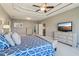 Spacious main bedroom boasts tray ceiling, ceiling fan, light gray walls, and en-suite bathroom at 5365 Vendelay Ln, Cumming, GA 30040